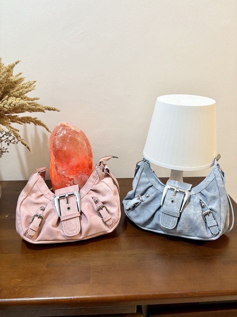 Y2K Buckle Denim Shoulder Bag Pink Blue (Category: Shoulder Bags) located in Binangonan. Submitted by blairmayie (Listing ID 1469444871, Image 1). Description: - Y2K style shoulder bag available in pink and light blue denim - Features trendy silver hardware, multiple decorative buckles, and stud accents - Secure top zipper closure with a structured slouchy shape - Comes with an adjustable shoulder strap for a custom fit - Available to purchase in