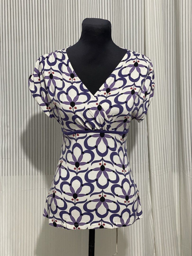Y2K Dynamite White Purple Flower Design Top (Category: Shirts) located in Tuguegarao City. Submitted by ziggerryy (Listing ID 1469536263, Image 1). Description: No flaws. S-M but can still strech for semi L Cotton Stretch material Ruched shoulder design .