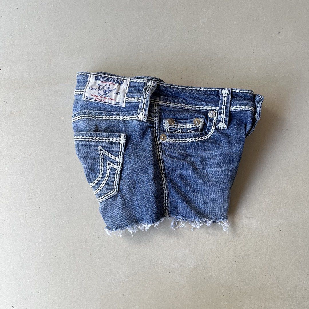 Y2k True Religion Denim Shorts (Category: Shorts) located in Mandaue City. Submitted by chinsyap_03 (Listing ID 1469468432, Image 2). Description: - Brand: True Religion - Style: Classic Y2K denim cutoffs - Wash: Medium blue - Waist: 26 inches - Length: 9 inches - Details: Signature thick white stitching, horseshoe back pockets, frayed raw hem, button fly, and back leather logo patch - Condition: Excellent pre-loved condition - Mode of Payment: G