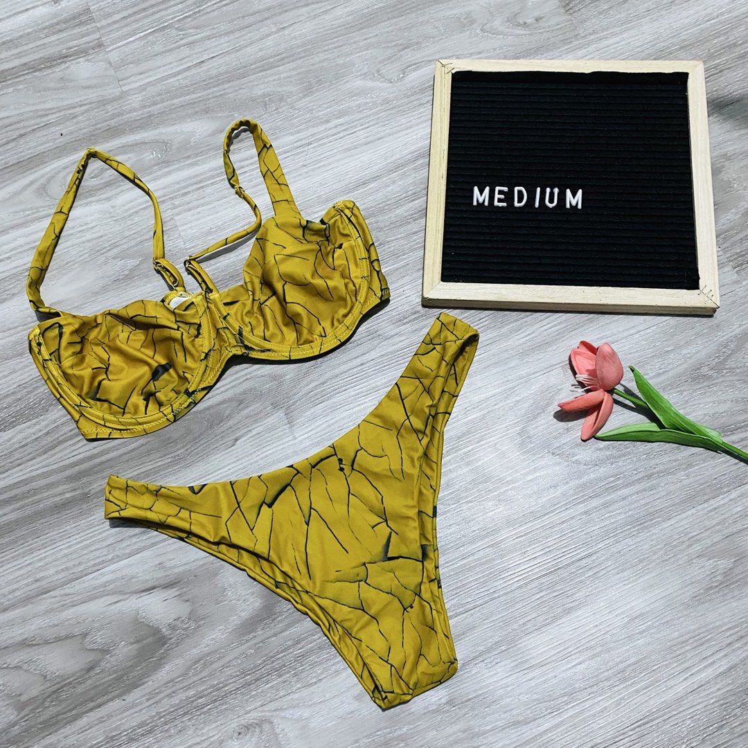 Yellow Crackle Print Underwire Bikini Set (Category: Bikinis & Swimsuits) located in Caloocan City. Submitted by lovemyclothes21 (Listing ID 1469497321, Image 1). Description: - Color: Yellow with black crackle pattern - Style: Two-piece bikini with underwire bra top and mid-rise bottoms - Features: Adjustable straps for a customized fit - Size: Medium - Condition: Great for beach or pool days.