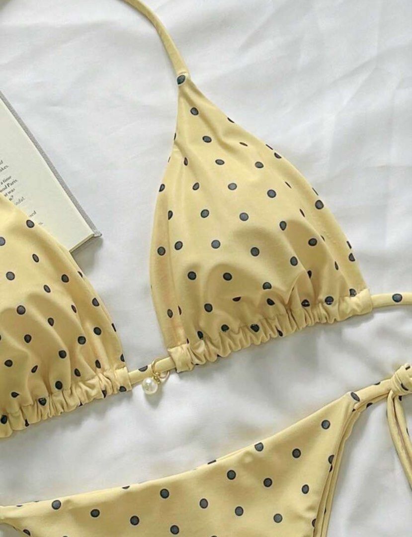 Yellow Polka Dot Bikini Pearl Charm Halter (Category: Bikinis & Swimsuits) located in Pasig City. Submitted by closetcleanoutmnl (Listing ID 1469512550, Image 3). Description: Yellow bikini set with dark polka dots all over. Halter neck top with adjustable triangle cups. Matching tie-side bottoms with adjustable coverage. Small faux pearl charm hanging between the top cups. Cute, playful style for sunny beach days or pool lounging. Unworn conditi