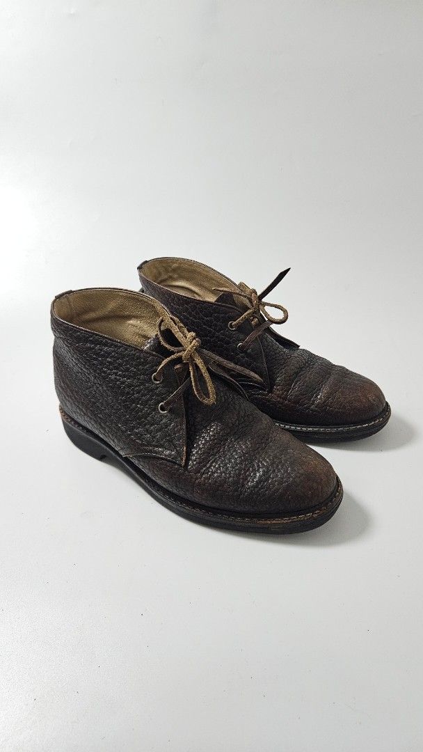 Yohji Yamamoto Leather Chukka Boots (Category: Boots) located in Alfonso. Submitted by jbcamet (Listing ID 1469515717, Image 1). Description: - Style: Classic dark brown textured leather chukka boots - Closure: Lace-up with thin leather laces - Interior: Comfortable cream lining - Soles: Durable black rubber with ribbed traction - Condition: Minimal wear on soles and uppers, excellent pre-loved condition - Versatility: Perfect for smart-casual an