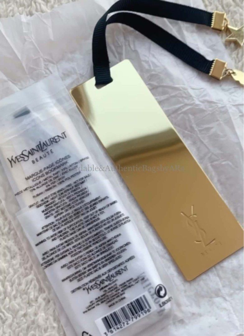 YSL BEAUTE BOOK MARK (Category: Luxury Accessories) located in Daet. Submitted by ecassenluxuries (Listing ID 1469405467, Image 1). Description: 📌 FIXED PRICE ALREADY 📍 Perfect pang gift sa Christmas ✅ All items are guaranteed 💯% AUTHENTIC GWP ITEM ▫️Item: Gold-tone metal bookmark ▫️Details: Features a black ribbon strap with star charms and YSL logo stamp ▫️Condition: Brand new, still sealed in original plastic packaging with barcode label in