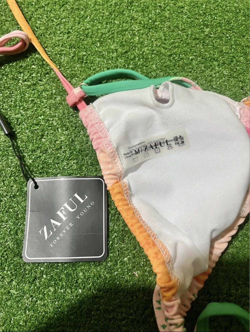 Zaful Multi-colored Bikini Set Size M (Category: Bikinis & Swimsuits) located in Bulacan. Submitted by lykaangel08 (Listing ID 1469553582, Image 2). Description: - RFS: Doesn’t fit - Brand: Zaful - Style: Two-piece swimsuit with triangle tie-top and high-cut cheeky side-tie bottoms - Print/Colors: Bright multi-color abstract pastel mix (pink, orange, and green) - Size: Medium (M) - Condition: Brand new with tags (BNWT), never worn - Material: Pol