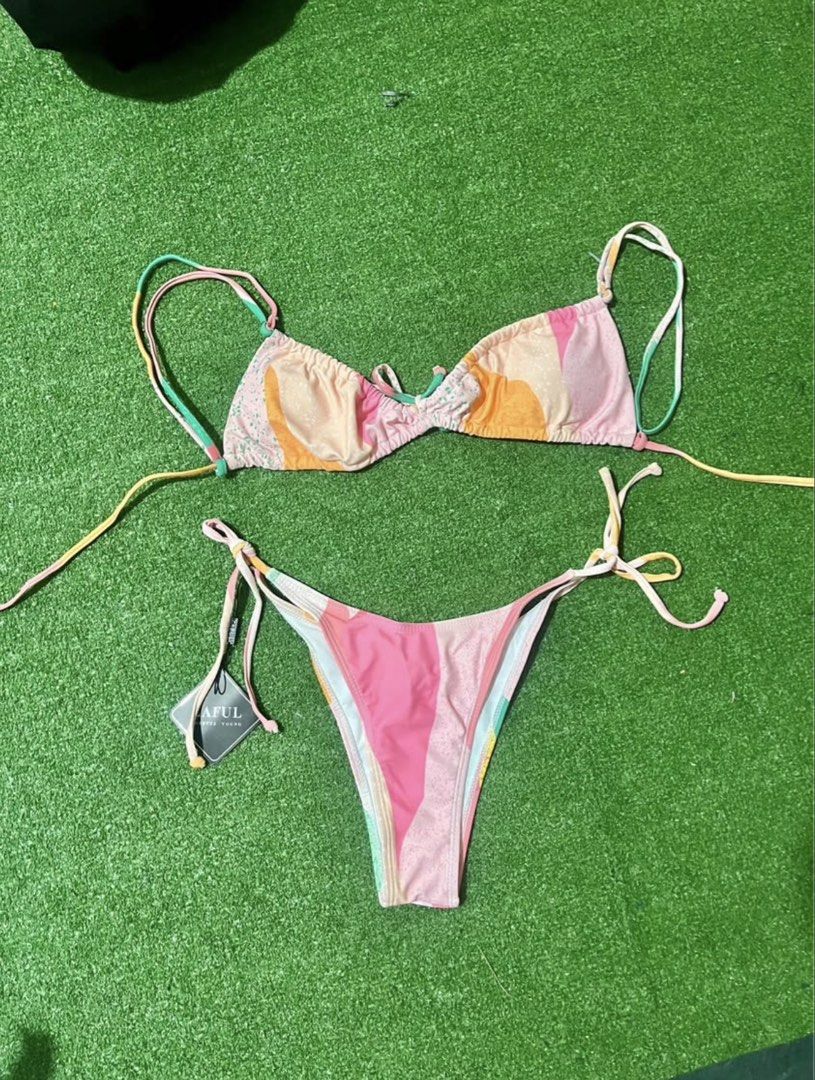 Zaful Multi-colored Bikini Set Size M (Category: Bikinis & Swimsuits) located in Bulacan. Submitted by lykaangel08 (Listing ID 1469553582, Image 1). Description: - RFS: Doesn’t fit - Brand: Zaful - Style: Two-piece swimsuit with triangle tie-top and high-cut cheeky side-tie bottoms - Print/Colors: Bright multi-color abstract pastel mix (pink, orange, and green) - Size: Medium (M) - Condition: Brand new with tags (BNWT), never worn - Material: Pol