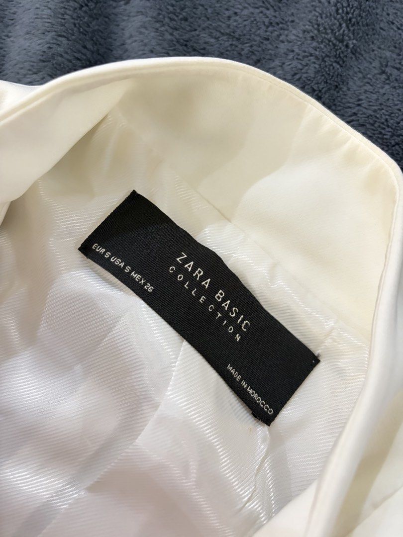 Zara Basic Collection Cream White Blazer Jacket Size S (Category: Coats, Jackets and Outerwear) located in Quezon City. Submitted by marifavo (Listing ID 1469446666, Image 2). Description: - Brand: Zara Basic Collection - Color: Cream White - Size: EUR S / USA S / MEX 26 - Design: Structured stand collar with single-button front closure - Pockets: Two front welt pockets - Lining: Fully lined interior - Origin: Made in Morocco - Condition: Excelle