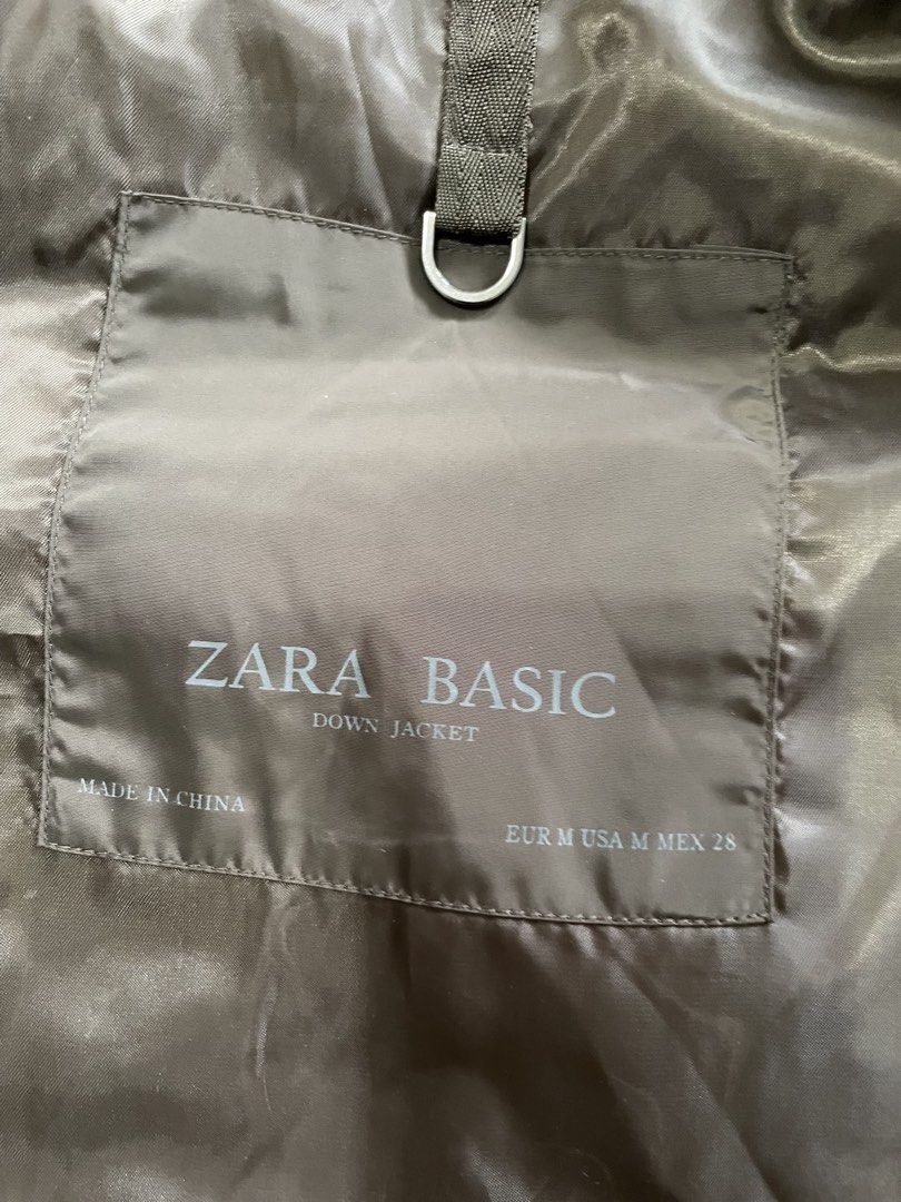 Zara Basic Down Jacket Brown Medium (Category: Coats, Jackets and Outerwear) located in Singapore. Submitted by calla_lala (Listing ID 1469475532, Image 1). Description: - Brand: Zara Basic - Style: Down jacket - Color: Brown with dark brown lining - Size: EUR M / USA M / MEX 28 - Features: Built-in hood, front zipper with snap buttons, angled zippered chest pockets, ribbed hem and cuffs - Origin: Made in China.
