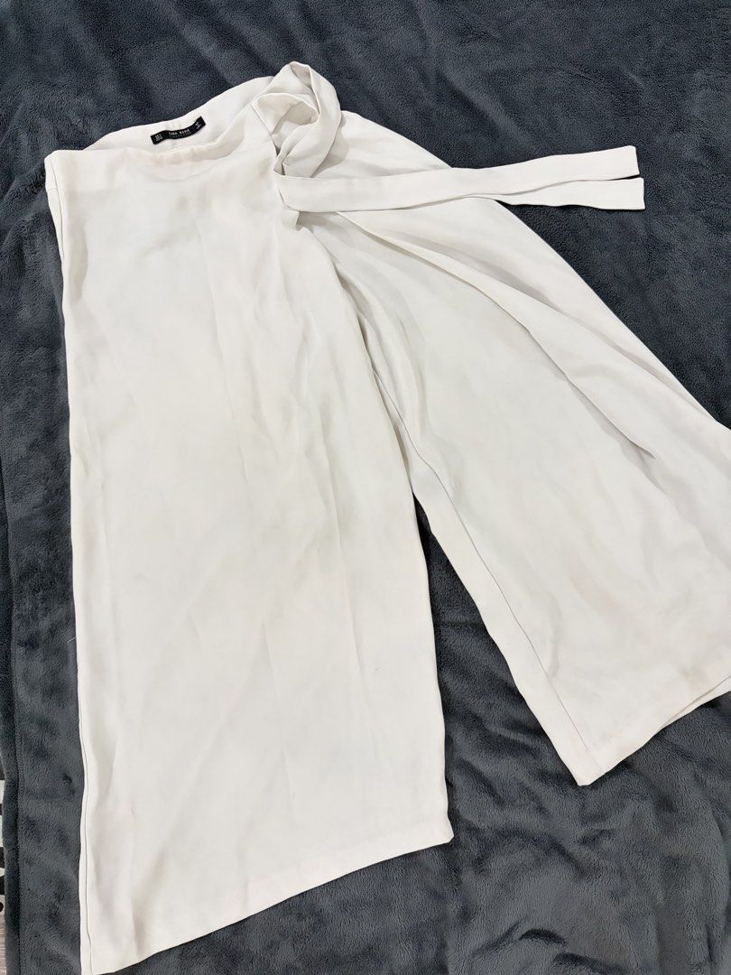 Zara Basic White Culottes Size S (Category: Shorts) located in Quezon City. Submitted by marifavo (Listing ID 1469446527, Image 1). Description: - Brand: Zara Basic - Size: S (EUR S, USA S, MEX 26) - Made in Turkey - Color: Clean White - Material: Lightweight fabric - Design: Wrap-style front panel with tie belt detail and wide-leg cut - Condition: Great versatile staple piece for everyday wear.
