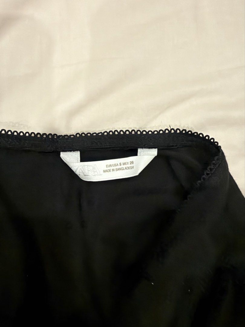 Zara Black Cap Sleeve Top (Category: Sleeveless) located in Manila. Submitted by pinkyclothes1267 (Listing ID 1469482660, Image 3). Description: - Brand: Zara - Size: S - Color: Classic Black - Material: Soft cotton blend with a smooth texture - Design: Scoop neckline with delicate scalloped trim, short cap sleeves, and stylish structured front paneling - Fit: Straight hem.