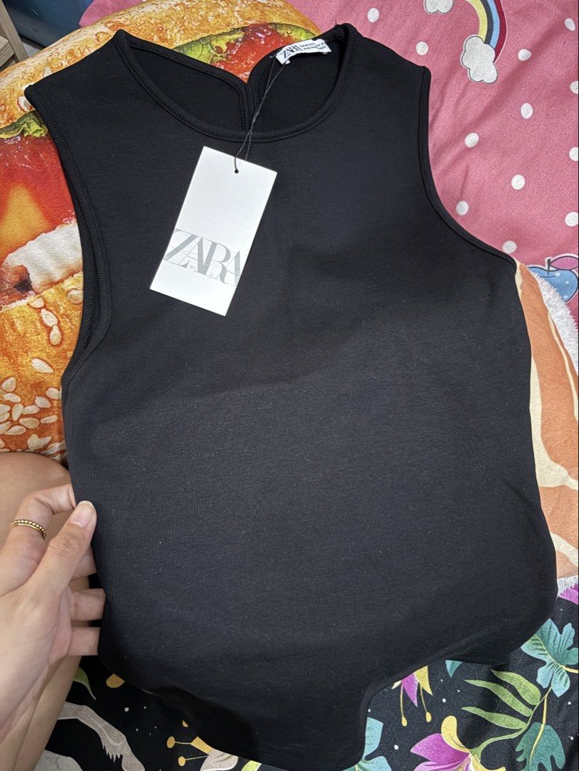Zara Black Sleeveless Open Back Tank Top (Category: Sleeveless) located in Quezon City. Submitted by mariebrnl (Listing ID 1469450666, Image 1). Description: - Brand: Zara - Size: Medium - Color: Solid black - Material: Ribbed fabric - Design: Sleeveless, high crew neckline, dramatic open back cutout - Condition: Brand new with original tags attached, unworn.
