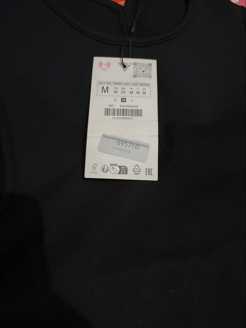 Zara Black Sleeveless Open Back Tank Top (Category: Sleeveless) located in Quezon City. Submitted by mariebrnl (Listing ID 1469450666, Image 2). Description: - Brand: Zara - Size: Medium - Color: Solid black - Material: Ribbed fabric - Design: Sleeveless, high crew neckline, dramatic open back cutout - Condition: Brand new with original tags attached, unworn.
