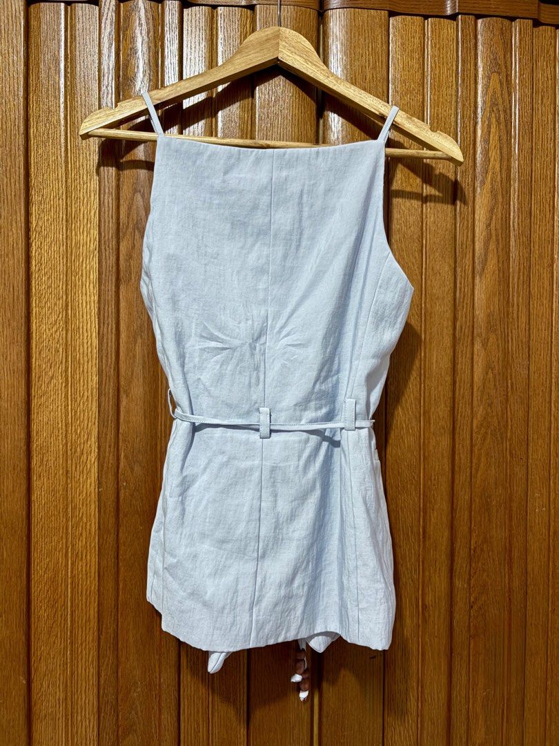 Zara Light Blue Button-Front Vest Top (Category: Sleeveless) located in Cavite. Submitted by momomochii (Listing ID 1469544190, Image 3). Description: - Brand: Zara - Color: Light blue - Size: EUR/USA XS - Design: Straight square neckline, thin straps, button-front closure, and tailored seams - Extra detail: Matching waist tie with beaded ends - Condition: likely new, no flaw.