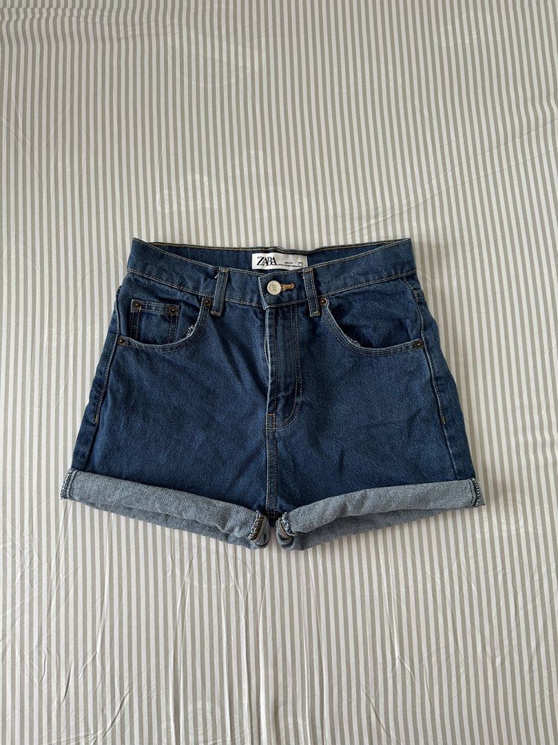 Zara Mom Fit Denim Shorts (Category: Shorts) located in Quezon City. Submitted by 4k_cam (Listing ID 1469453502, Image 1). Description: - Brand: Zara - Style: Mom fit denim shorts - Color/Wash: Dark blue wash - Design: Cuffed hems, classic five-pocket style with contrast stitching - Hardware: Silver-toned metal button closure.