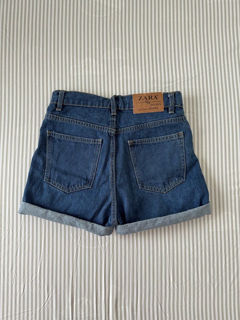Zara Mom Fit Denim Shorts (Category: Shorts) located in Quezon City. Submitted by 4k_cam (Listing ID 1469453502, Image 2). Description: - Brand: Zara - Style: Mom fit denim shorts - Color/Wash: Dark blue wash - Design: Cuffed hems, classic five-pocket style with contrast stitching - Hardware: Silver-toned metal button closure.