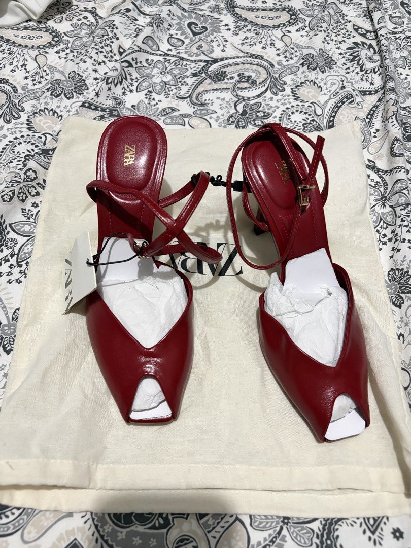 Zara Red Stiletto Heel / Open-Toe Ankle-Strap Sandals (Category: Heels) located in Mapandan. Submitted by thrifty.nifty.tara (Listing ID 1469490748, Image 3). Description: • Brand: Zara • Color: Red / Burgundy / Cherry • Style: Open-toe stiletto heels with cross-over / ankle bracelet straps • Design Features: Pointed front with a small toe opening and slim stiletto heels Size on tag: 37eu.