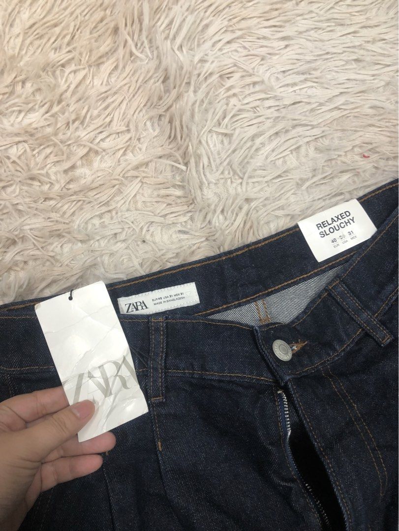 ZARA Wide Pleated Dark Denim Jeans (Category: Jeans) located in Angeles City. Submitted by maryannsantos (Listing ID 1469466735, Image 3). Description: - Brand: ZARA - Condition: Brand new with original tags, never worn - Style: Relaxed slouchy fit with pleated front and high-rise waist - Wash: Dark wash with classic contrast stitching - Details: Zipper fly, button closure, and classic five-pocket design - Size: EUR 40 / USA 31 / MEX 31.