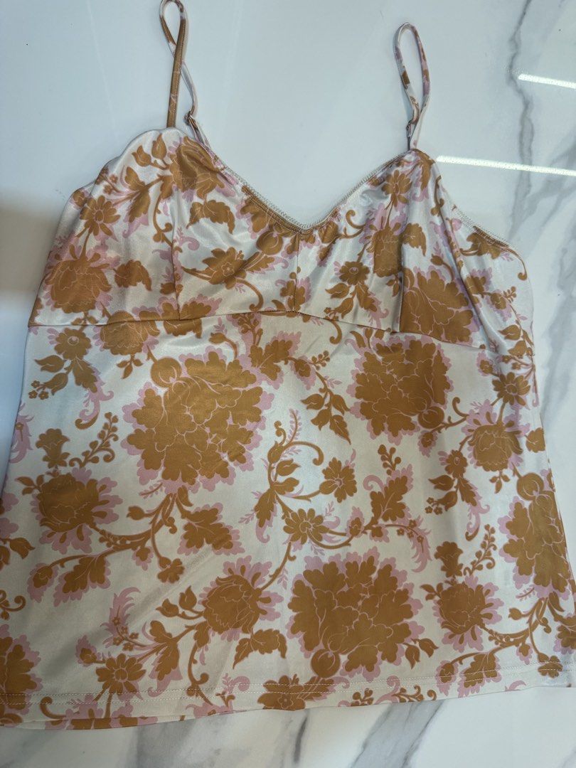 Zimmermann floral camisole top size 2 (Category: Sleeveless) located in Manila. Submitted by decluterthings888 (Listing ID 1469505829, Image 1). Description: - Brand: Zimmermann - Style: Floral camisole top - Color: Cream base with golden brown and pink floral print - Size: 2 - Details: Delicate adjustable spaghetti straps, V-neckline with piped trim - Fabric: Light and silky - Condition: Excellent, well-maintained - Perfect for layering or stand
