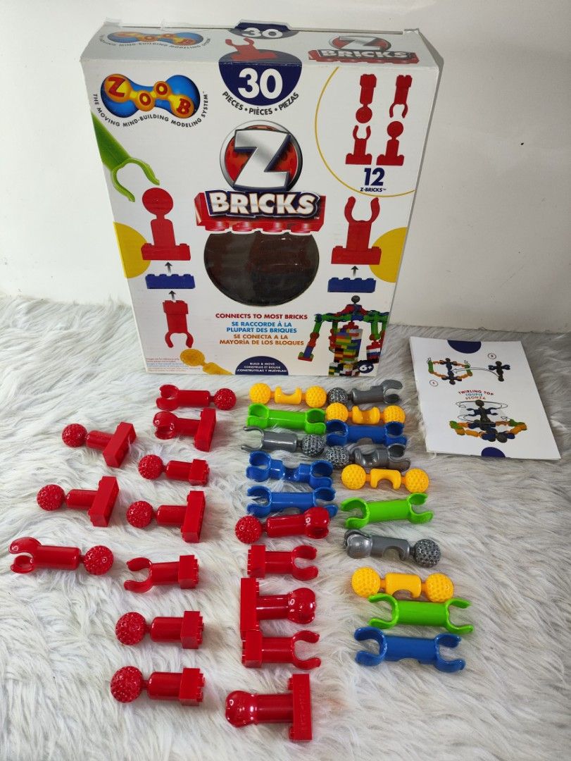 ZOOB Z-Bricks 30 Pieces Building System (Category: Lego & Building Sets) located in Cavite. Submitted by tinetaclesss (Listing ID 1469496467, Image 1). Description: - Authentic ZOOB Z-Bricks construction toy set - Includes 30 colorful pieces (red, blue, green, yellow, and grey) - Comes with an instruction manual for a twirling top and other creative builds - Perfect gift or addition to your child's building toy collection.