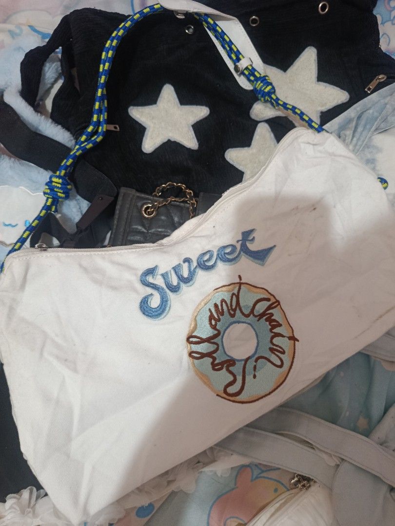 10pcs canvas shoulder bags (Category: Shoulder Bags) located in Manila. Submitted by jessica02_deer (Listing ID 1469672748, Image 2). Description: - Material: Durable bags - Design: Embroidered 'Sweet' text with a large frosted donut graphic - Strap: Eye-catching blue and yellow patterned rope with knot details - Closure: Secure top zipper to keep your essentials safe - Style: Casual, fun, and perfect for everyday outfits - Condition: Brand new a