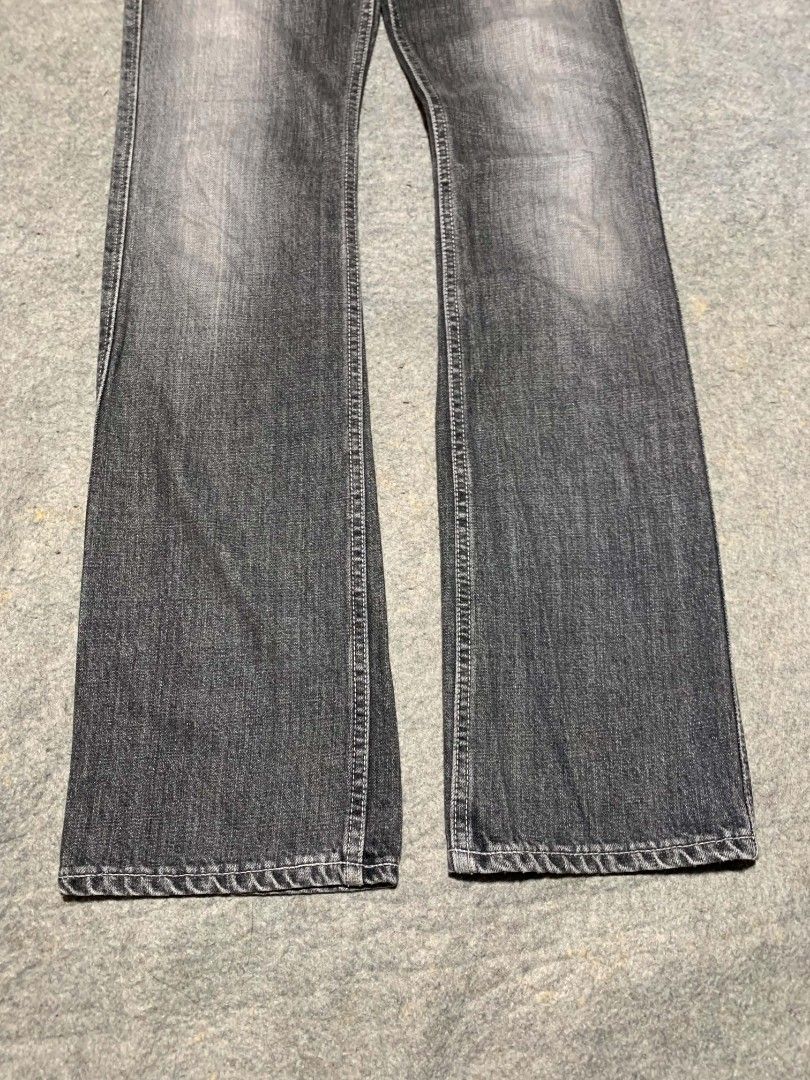 2000's Lee Japan Washed Black Flared Cargo Jeans (Category: Jeans) located in Bislig. Submitted by rndm_stff1 (Listing ID 1469604462, Image 2). Description: Rare Japanese archive piece from Lee Japan (licensed by Edwin Co., Ltd.). Features a washed faded black/charcoal denim body, dual front button-flap cargo pockets, flap back pockets, and custom branded metal buttons. Flared bootcut silhouette with 100% cotton Japanese construction. Details: - 