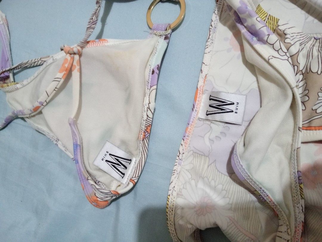 2-piece Bikini Set (Category: Bikinis & Swimsuits) located in Makati City. Submitted by YSL80022 (Listing ID 1469677226, Image 3). Description: - Brand: W Swim - Size: Medium (M, with brand tags attached) - Print/Color: Vintage floral in purple, orange, and white - Details: Chic gold-tone ring hardware accents on top and bottoms - Style: Halter neck tie top with matching bikini bottoms - Condition: used.