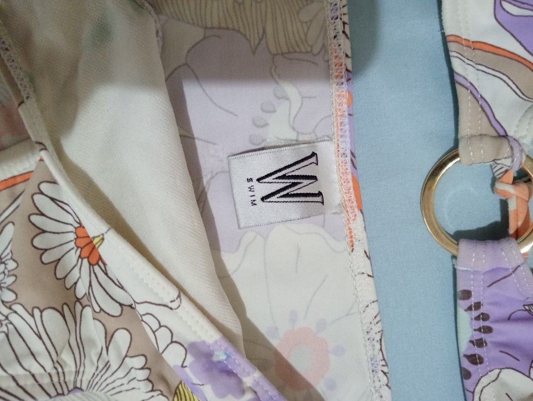 2-piece Bikini Set (Category: Bikinis & Swimsuits) located in Makati City. Submitted by YSL80022 (Listing ID 1469677226, Image 2). Description: - Brand: W Swim - Size: Medium (M, with brand tags attached) - Print/Color: Vintage floral in purple, orange, and white - Details: Chic gold-tone ring hardware accents on top and bottoms - Style: Halter neck tie top with matching bikini bottoms - Condition: used.