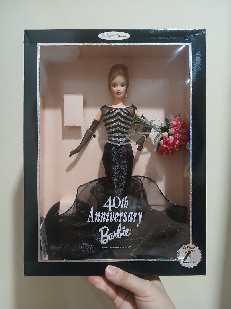 40th Anniversary Barbie Collector Edition Doll (Category: Figurines & Statues) located in Subic. Submitted by frncnjntmr22 (Listing ID 1469741496, Image 1). Description: - Edition: Collector Edition 40th Anniversary Barbie - Outfit: Stunning black dress with glittery silver bodice details, black gloves, and drop earrings - Accessories: Includes a bouquet of pink roses and a miniature replica of the original 1959 bathing suit doll - Condition: Ori