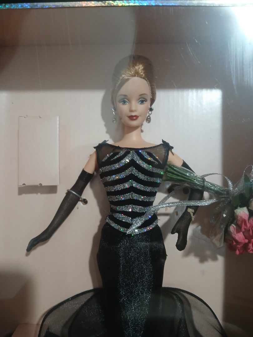 40th Anniversary Barbie Collector Edition Doll (Category: Figurines & Statues) located in Subic. Submitted by frncnjntmr22 (Listing ID 1469741496, Image 2). Description: - Edition: Collector Edition 40th Anniversary Barbie - Outfit: Stunning black dress with glittery silver bodice details, black gloves, and drop earrings - Accessories: Includes a bouquet of pink roses and a miniature replica of the original 1959 bathing suit doll - Condition: Ori