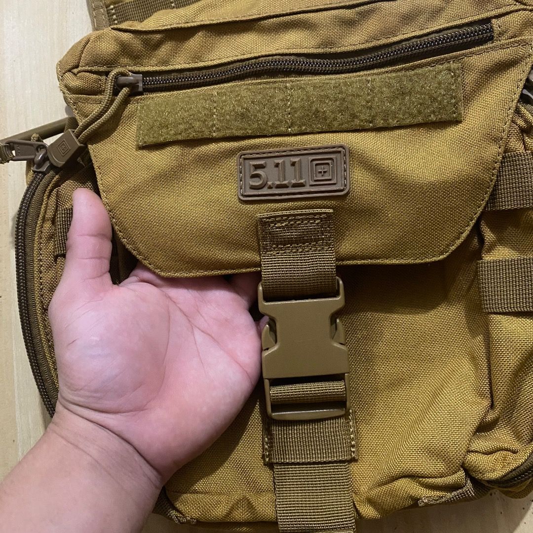 5.11 Tactical Rush Moab 10 Sling Bag Coyote (Category: Sling Bags) located in Bacolod City. Submitted by jeybe112019 (Listing ID 1469612902, Image 2). Description: - Brand: 5.11 Tactical - Color: Coyote Brown - Material: Heavy-duty, durable nylon - Compartments: Multiple zippered pockets and internal mesh organizers - Customization: MOLLE webbing and velcro panels for patches on the front and strap - Fit: Adjustable shoulder strap with secure buc