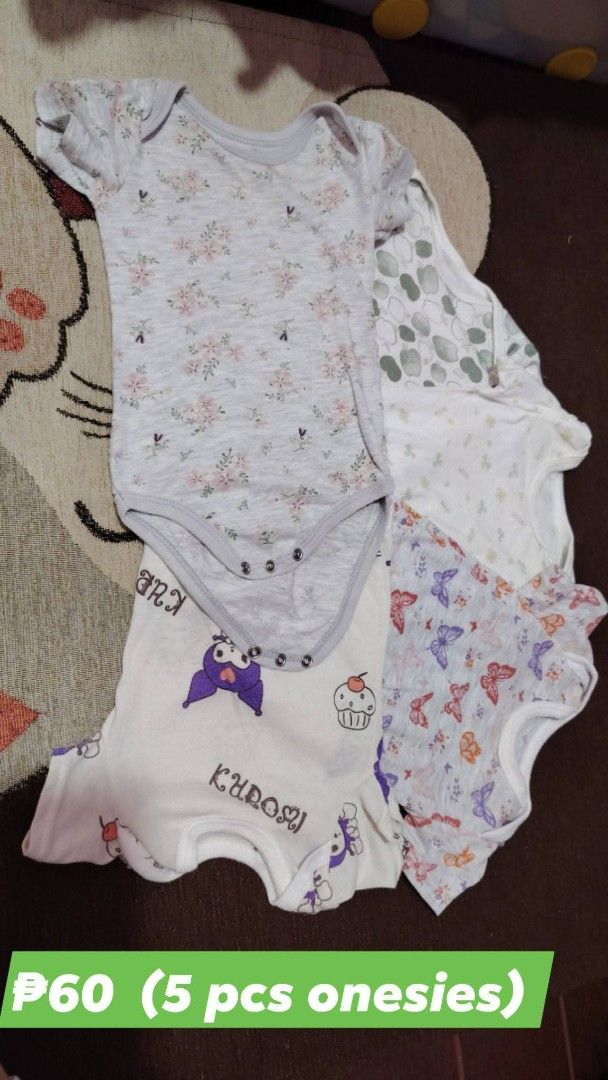 5 pcs baby onesies assorted prints (Category: Babies & Kids Fashion) located in Quezon City. Submitted by livebird_b3d174 (Listing ID 1469744626, Image 1). Description: - Set of 5 baby onesies made from soft, breathable cotton - Features convenient short sleeves and bottom snap button closures - Includes 5 adorable designs: grey floral, green apple pattern, white floral, white butterfly print, and Kuromi - Sold together as a bundle set - Perfect 
