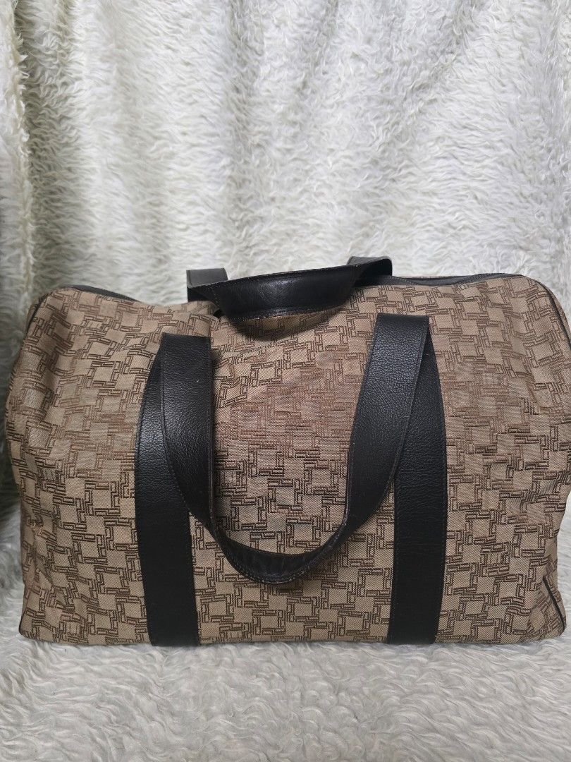 💯% AUTHENTIC Dunhill Geometric Pattern Travel Bag with Black Handles (Category: Tote Bags) located in Marikina City. Submitted by dust.end.bags (Listing ID 1469620211, Image 1). Description: - Stylish brown and beige pattern with contrast dark faux leather handles - Spacious interior ideal for weekend trips or gym gear - Structured design with a sturdy bottom to keep its shape - Secure top zip closure for safe travels - Features double top handl