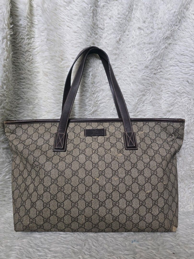 💯% AUTHENTIC Gucci GG Supreme Monogram Tote Bag (Category: Tote Bags) located in Marikina City. Submitted by dust.end.bags (Listing ID 1469608548, Image 1). Description: - Authentic Gucci tote bag in classic GG Supreme monogram canvas - Elegant brown leather trim and sturdy double shoulder straps - Open-top design with a spacious interior for your daily essentials - Condition: Shows some surface wear and spots on the canvas and edges from regula