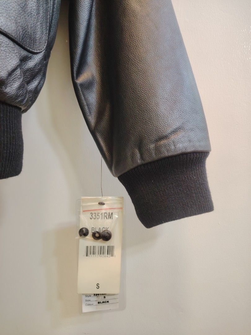 A-2 LEATHER FLIGHT JACKET (Category: Coats, Jackets and Outerwear) located in La Trinidad. Submitted by padasem_kadi (Listing ID 1469631999, Image 3). Description: - Style: Classic black leather bomber jacket - Condition: Brand new with original store tag attached - Details: Front zipper closure, rib-knit cuffs and hem, dual front flap pockets - Extras: Includes extra buttons - Size: Small - Measurements: Chest 23 inches, Length 26 inches, Sleeve