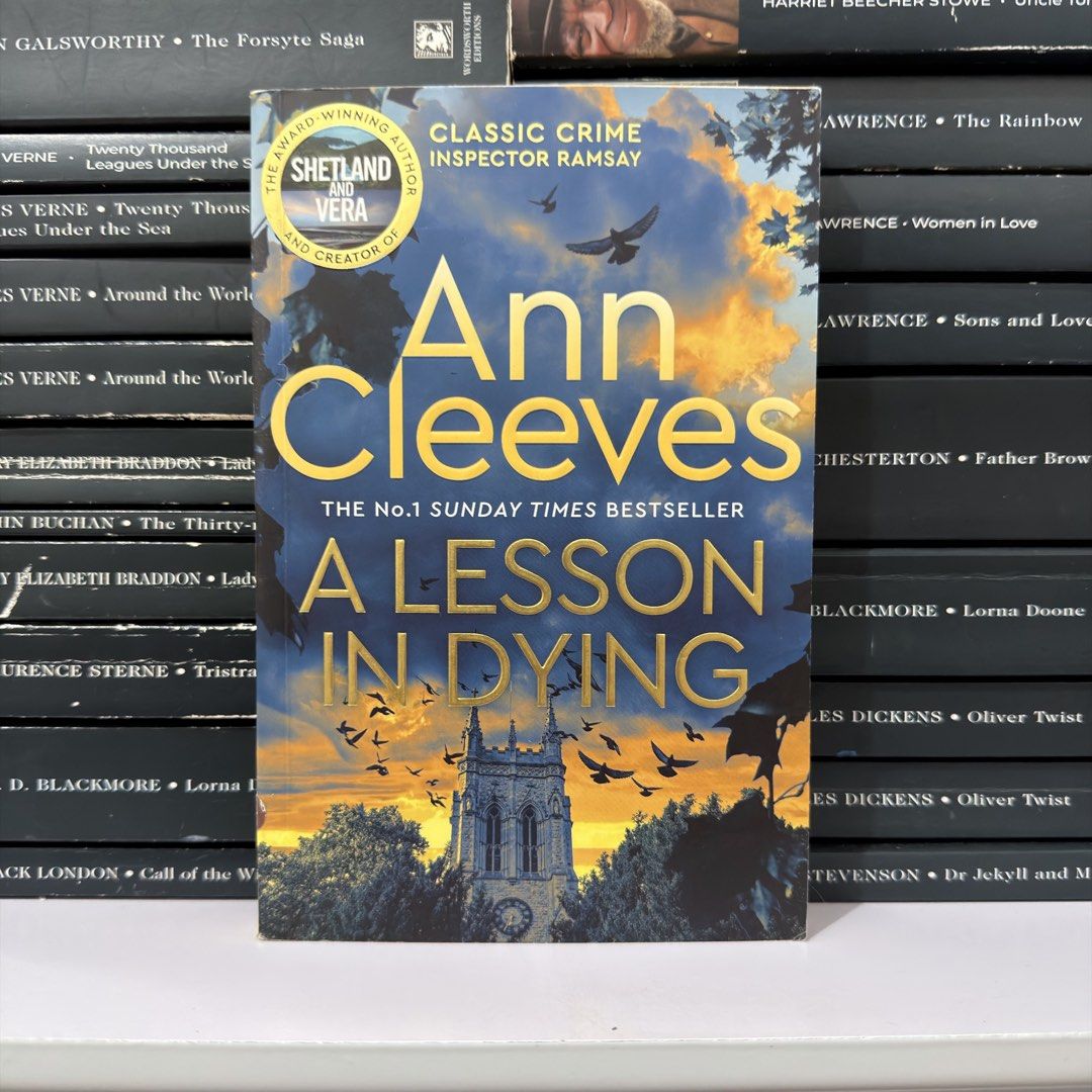 A Lesson in Dying by Ann Cleeves (Category: Storybooks) located in Lingayen. Submitted by readwjane (Listing ID 1469592421, Image 1). Description: - Title: Inspector Ramsay Series Crime Fiction Novel - Author: Ann Cleeves - Format: Paperback - Cover Design: Birds and church tower artwork - Condition: Great read for mystery and thriller fans - Shipping or meet-up available across the PH.