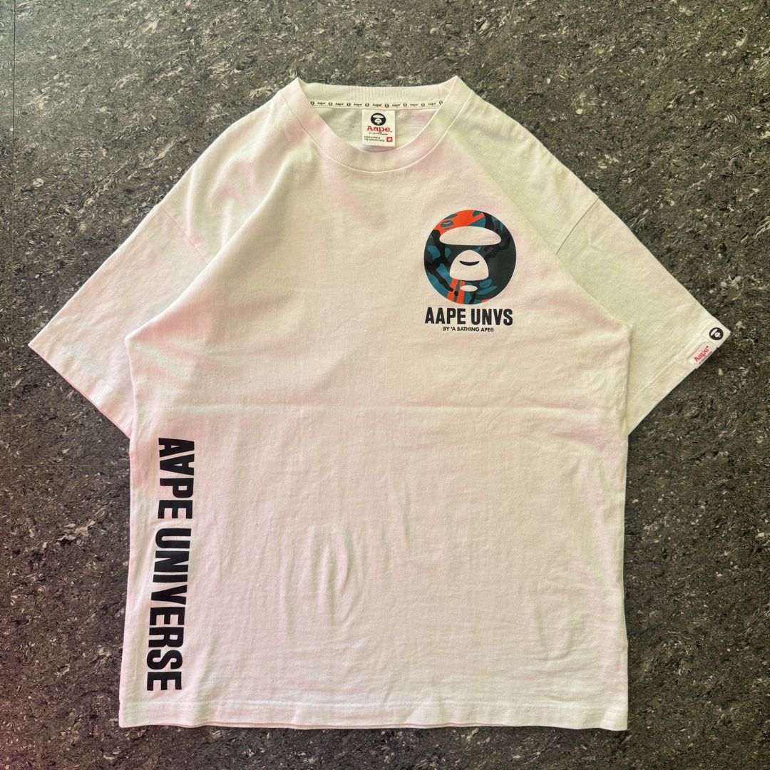 Aape by a bathing ape (Category: Formal Shirts) located in Bulacan. Submitted by b4mzz (Listing ID 1469638843, Image 2). Description: AAPE UNVS Tee 🦍 Clean white graphic tee featuring the signature AAPE UNVS design. Authentic piece with standout streetwear details. 📏 Width: 22” | Length: 28” 🎨 Color Rate: 10/10 ⚠️ Issue: Minimal pinhole 💬 Open for reasonable offers!.
