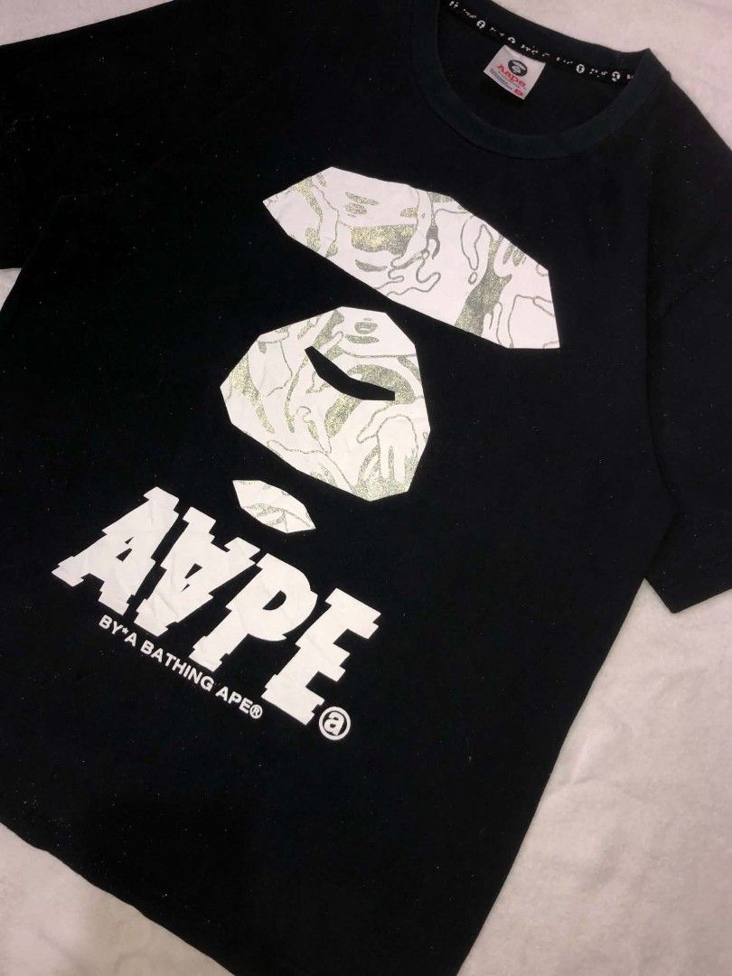 Aape By A Bathing Ape Black Graphic Tee (Category: Tshirts & Polo Shirts ) located in Daet. Submitted by quickearth.ac7e7e (Listing ID 1469697620, Image 3). Description: - Brand: Aape - Color: Black with signature camo ape head graphic - Details: White text print on back, sleeve tag - Fit: Regular fit, short sleeves, crew neck - Material: 100% Cotton - Size: 170/88A - Shipping or meetups available across Metro Manila.