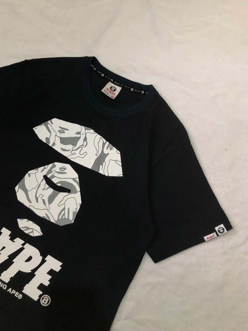 Aape By A Bathing Ape Black Graphic Tee (Category: Tshirts & Polo Shirts ) located in Daet. Submitted by quickearth.ac7e7e (Listing ID 1469697620, Image 2). Description: - Brand: Aape - Color: Black with signature camo ape head graphic - Details: White text print on back, sleeve tag - Fit: Regular fit, short sleeves, crew neck - Material: 100% Cotton - Size: 170/88A - Shipping or meetups available across Metro Manila.