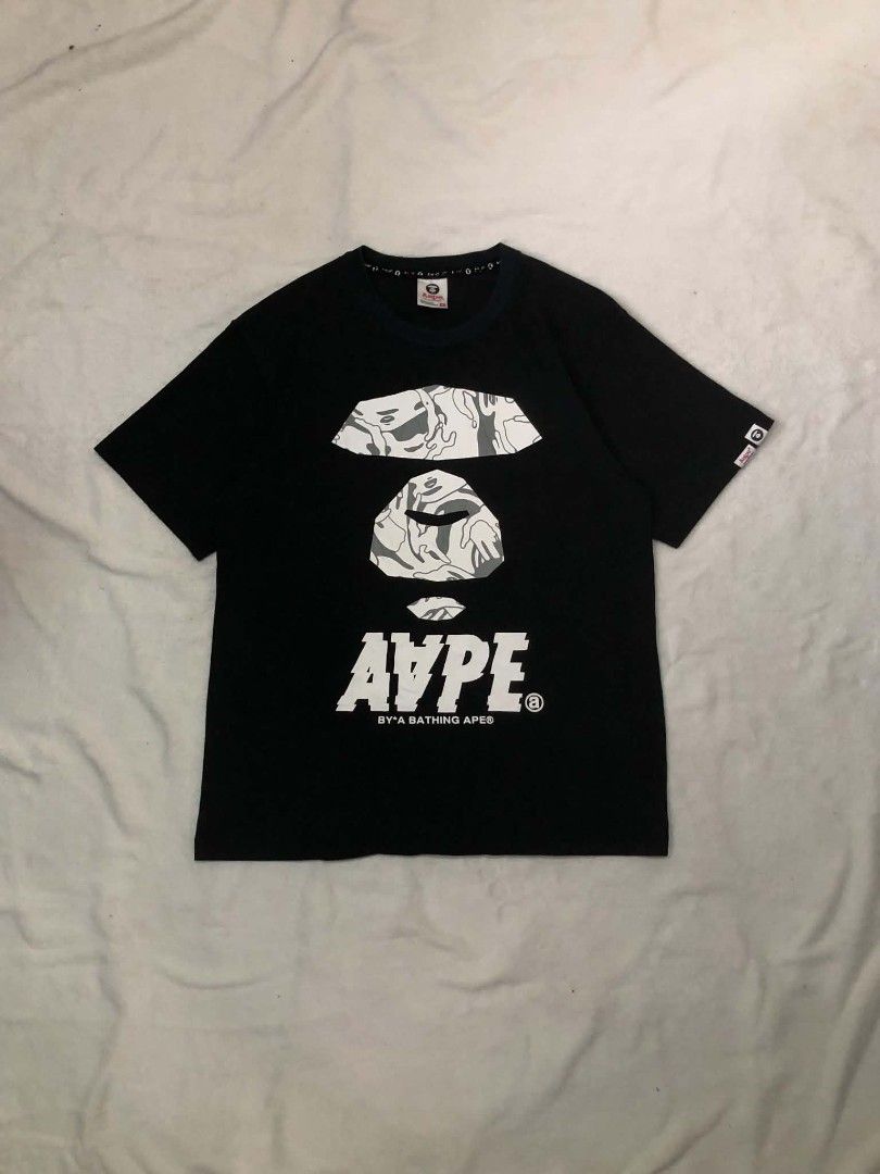 Aape By A Bathing Ape Black Graphic Tee (Category: Tshirts & Polo Shirts ) located in Daet. Submitted by quickearth.ac7e7e (Listing ID 1469697620, Image 1). Description: - Brand: Aape - Color: Black with signature camo ape head graphic - Details: White text print on back, sleeve tag - Fit: Regular fit, short sleeves, crew neck - Material: 100% Cotton - Size: 170/88A - Shipping or meetups available across Metro Manila.