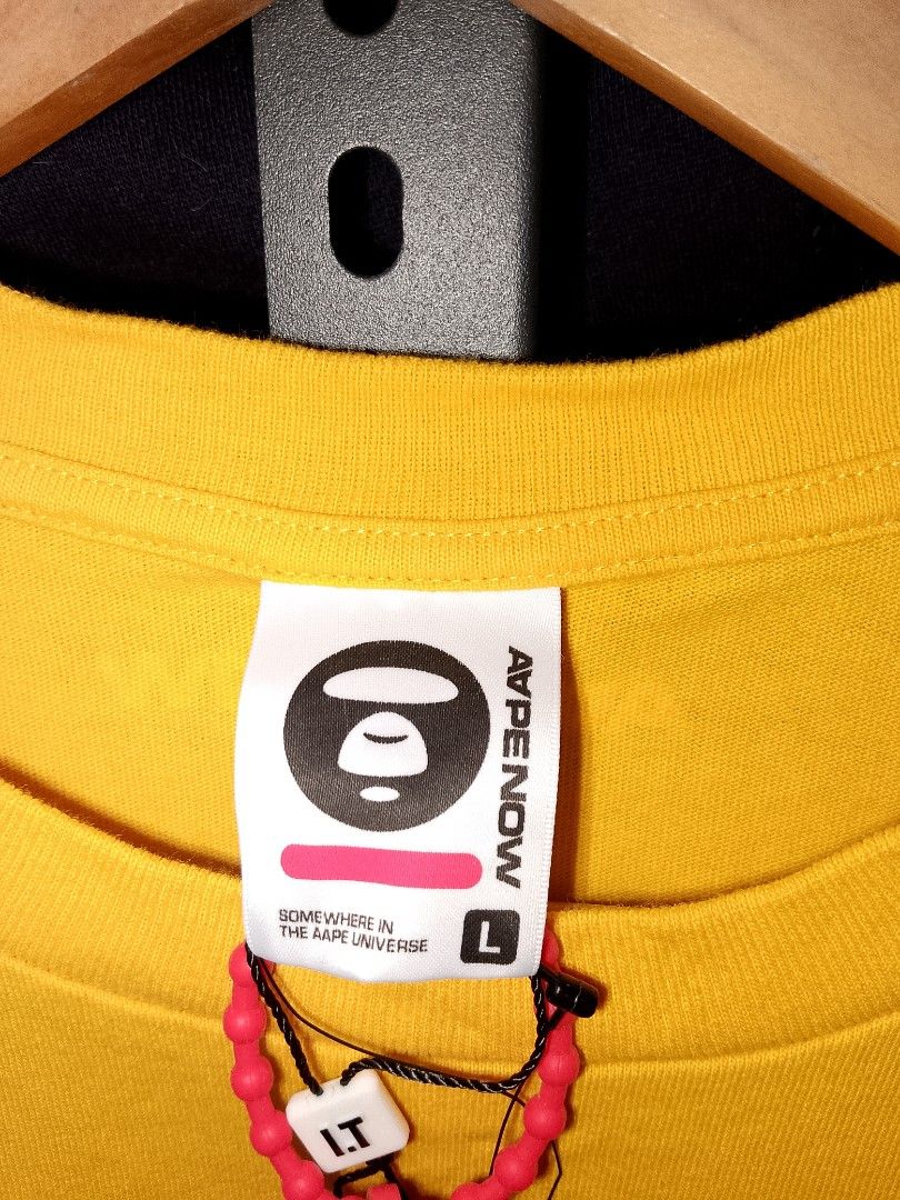 AAPE NOW Yellow Long Sleeve Tee (Category: Tshirts & Polo Shirts ) located in Manila. Submitted by mjthrifted_second (Listing ID 1469638798, Image 3). Description: - Brand: AAPE NOW - Item: Bright yellow long sleeve t-shirt - Size: Large (L) -Dimes: 20/27 - Condition: Brand new with tags attached, never worn - Details: Graphic text on sleeves and back collar, embroidered ape head logo on chest - Style: Clean, vibrant piece perfect for everyday st