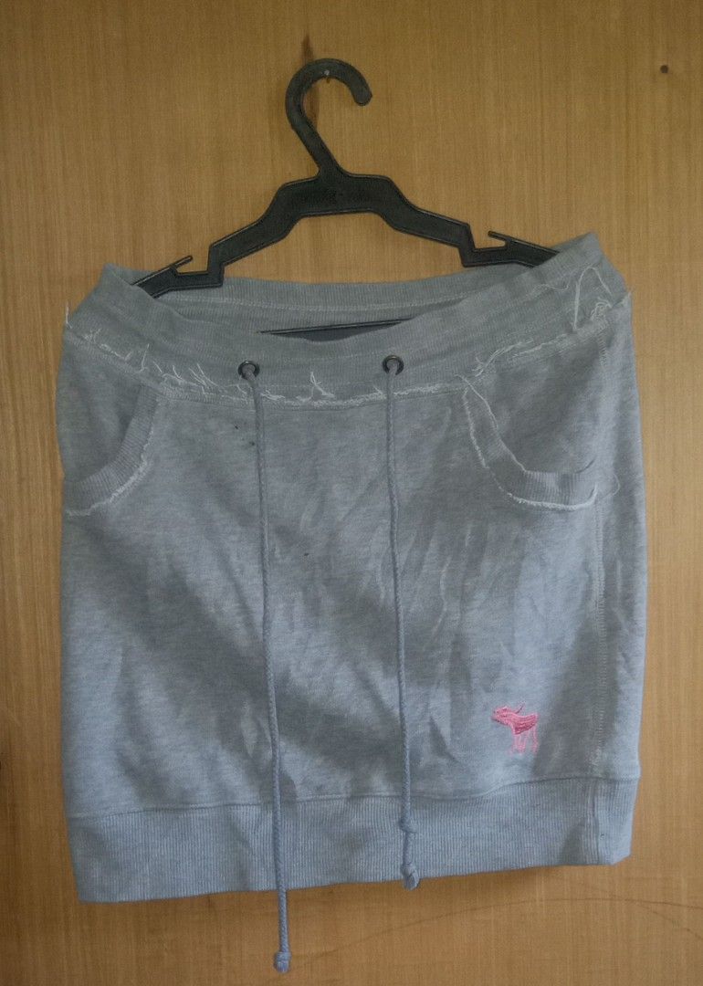 Abercrombie Grey Sweatshirt Skirt (Category: Skirts) located in Manila. Submitted by thrift_ni_jan (Listing ID 1469576910, Image 1). Description: - Brand: Abercrombie & Fitch - Style: Casual grey cotton sweat skirt - Details: Distressed raw edge waistband with adjustable drawstrings - Pockets: Two functional front pockets - Accents: Cute pink embroidered moose logo near the bottom hem - Fit: Comfortable, ribbed bottom hem, easy to style for daily