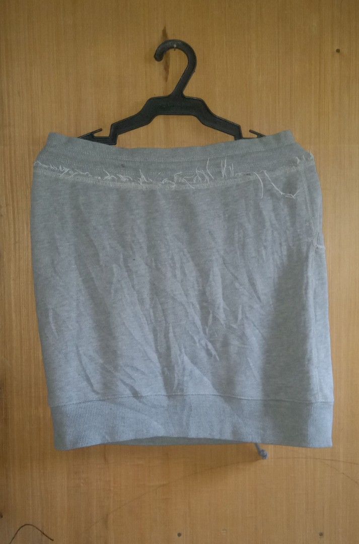 Abercrombie Grey Sweatshirt Skirt (Category: Skirts) located in Manila. Submitted by thrift_ni_jan (Listing ID 1469576910, Image 2). Description: - Brand: Abercrombie & Fitch - Style: Casual grey cotton sweat skirt - Details: Distressed raw edge waistband with adjustable drawstrings - Pockets: Two functional front pockets - Accents: Cute pink embroidered moose logo near the bottom hem - Fit: Comfortable, ribbed bottom hem, easy to style for daily