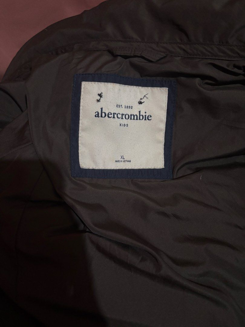 Abercrombie Kids Puffer Jacket XL (Category: Coats, Jackets and Outerwear) located in Pasay City. Submitted by 2000smaria (Listing ID 1469642684, Image 3). Description: - Brand: Abercrombie Kids - Item: Winter Puffer Jacket - Color: Dark Brown - Size: XL on tags - Design: Quilted with a cinched back waist for a flattering fit - Features: Stand-up collar, double zip closure with snap buttons, and zippered front pockets - Branding: Embroidered moos