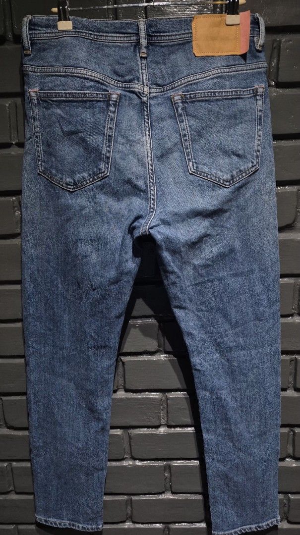 Acne Studios Blue Denim Jeans (Category: Jeans) located in Davao. Submitted by rodrigoani57168 (Listing ID 1469673143, Image 2). Description: - Brand: Acne Studios - Color/Wash: Classic medium blue with subtle fading - Fit: Straight fit - Details: Button fly closure with branded hardware, signature pink brand patch on the back waistband - Material: Structured cotton denim - Condition: Excellent everyday staple piece - Ships securely from the Phil