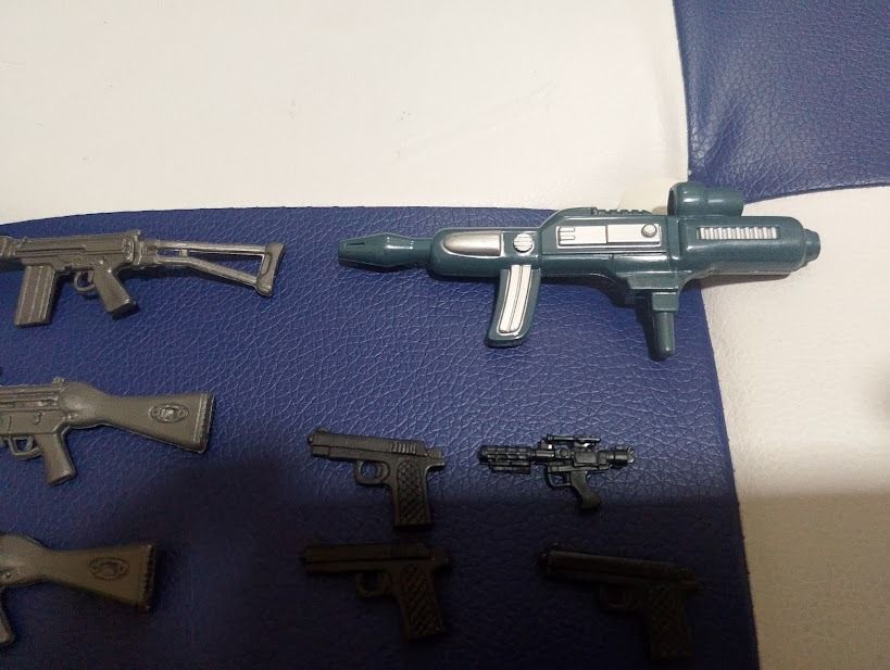 Action Figure Toy Weapons Guns Swords Set (Category: Action & Battle Toys) located in Quezon City. Submitted by susmaryosep1 (Listing ID 1469652953, Image 2). Description: - Lot of assorted miniature action figure weapons - Includes rifles, submachine guns, handguns, sci-fi blasters, throwing stars, knives, and axes - Mostly silver and grey plastic material - Great for figure customizing, diorama setups, or replacing lost accessories - All pieces