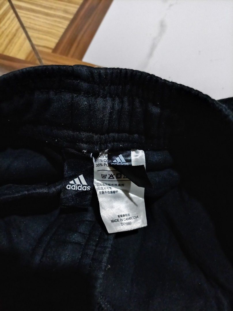 Adidas Black Joggers Pants DV1660 (Category: Joggers) located in Naga. Submitted by catimbange25697 (Listing ID 1469710716, Image 2). Description: - Brand: Adidas - Color: Black with large white logo on the leg - Material: Comfortable cotton and polyester blend - Fit: Regular fit with elastic waistband and adjustable drawstring - Origin: Made in Cambodia - Versatility: Ideal for workouts, lounging, or casual daily wear.