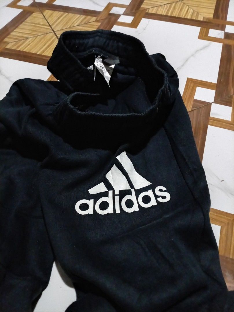 Adidas Black Joggers Pants DV1660 (Category: Joggers) located in Naga. Submitted by catimbange25697 (Listing ID 1469710716, Image 3). Description: - Brand: Adidas - Color: Black with large white logo on the leg - Material: Comfortable cotton and polyester blend - Fit: Regular fit with elastic waistband and adjustable drawstring - Origin: Made in Cambodia - Versatility: Ideal for workouts, lounging, or casual daily wear.