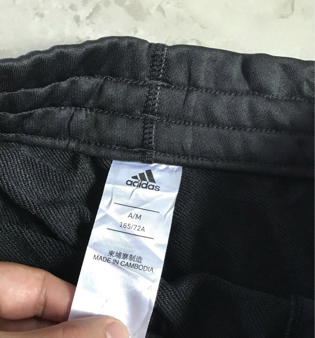 Adidas Black Shorts with Logo (Category: Shorts) located in Banga. Submitted by jorguarino (Listing ID 1469622793, Image 3). Description: Adidas athletic shorts in black. Size A/M (165/72A). Made of 100% recycled polyester main material with cotton blend pocket lining. Elastic waistband with drawstring. Bold white adidas vertical logo print on the leg. Manufactured in Cambodia..