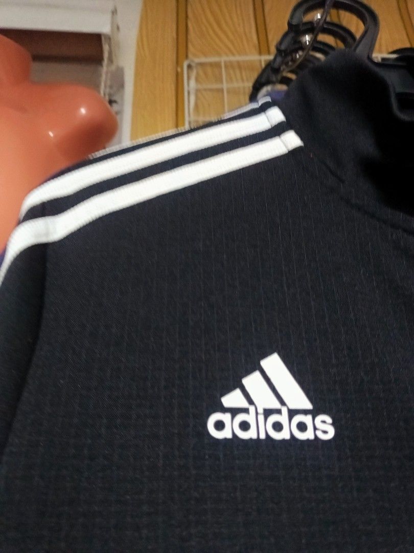 Adidas Black Track Jacket with White Stripes Size S (Category: Coats, Jackets and Outerwear) located in General Trias. Submitted by felgemdedi33956 (Listing ID 1469616834, Image 2). Description: - Brand: Adidas - Style: Track jacket with full zip, mock neck, and zipped pockets - Color/Design: Black with classic white three stripes and 'BETTY' text print on the left chest - Size: Small (tag) - Material: 100% polyester.