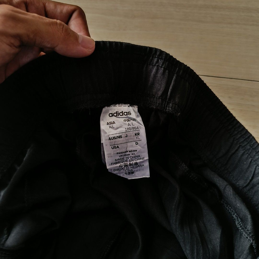 Adidas Black Track Pants (Category: Joggers) located in Manila. Submitted by ghello99 (Listing ID 1469628033, Image 2). Description: - Brand: Adidas - Color: Classic Black with bold white logo on left lower leg - Size: Asia A/L (Height 180/86A) - Fit: Elastic waistband with adjustable drawstring - Condition: Great / Well-maintained - Origin: Made in China - Best for: Gym workouts, sports, or casual streetwear/lounging.