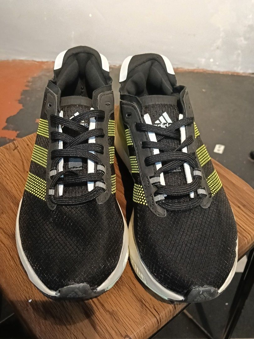 Adidas Black Yellow Running Shoes (Category: Sneakers) located in Manila. Submitted by mariarezap86451 (Listing ID 1469716729, Image 1). Description: - Brand: Adidas - Color: Black with yellow dotted stripes, olive heel counter - Sole: Chunky white and black midsole - Design: Breathable mesh upper, black laces, and white collar pull tabs - Use: Perfect for workouts, gym sessions, or casual daily walks - Condition: Good everyday trainers.